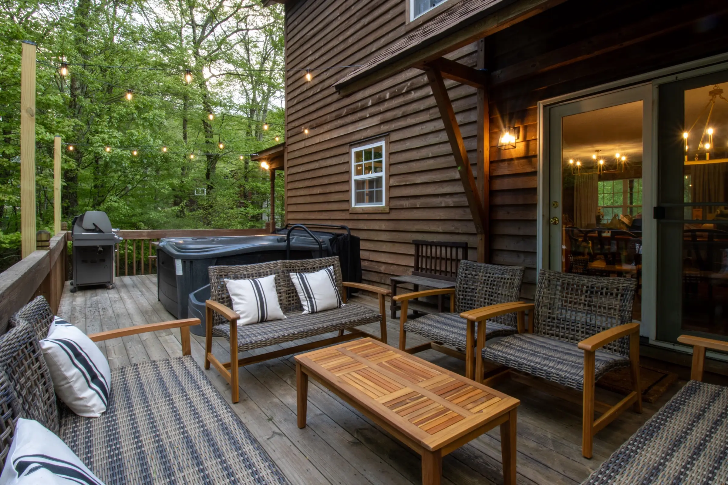 The rear deck seating area, with wicker furniture and sliding doors to the dining room.