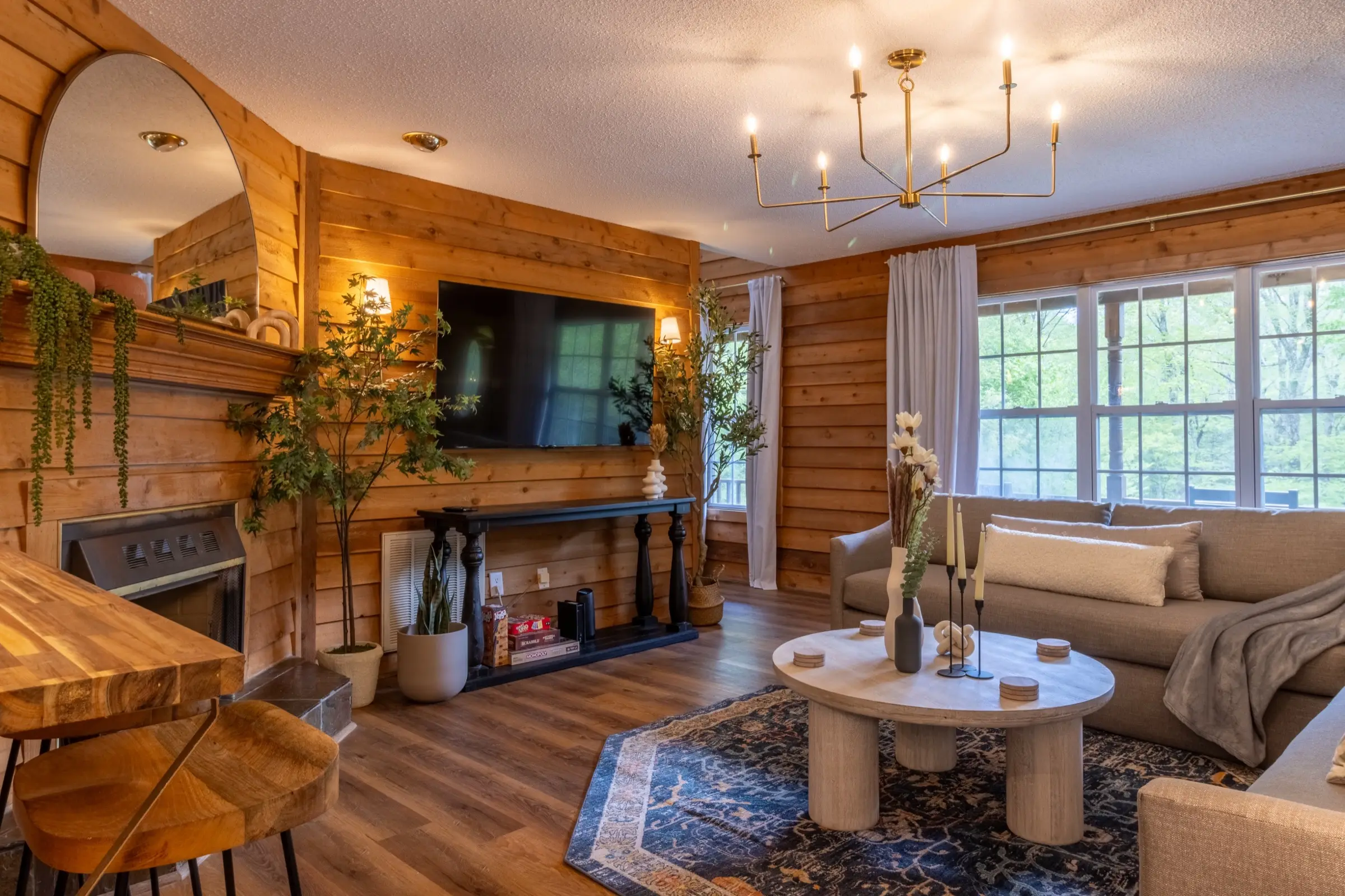 The living room, with two sofas facing the television and fireplace.