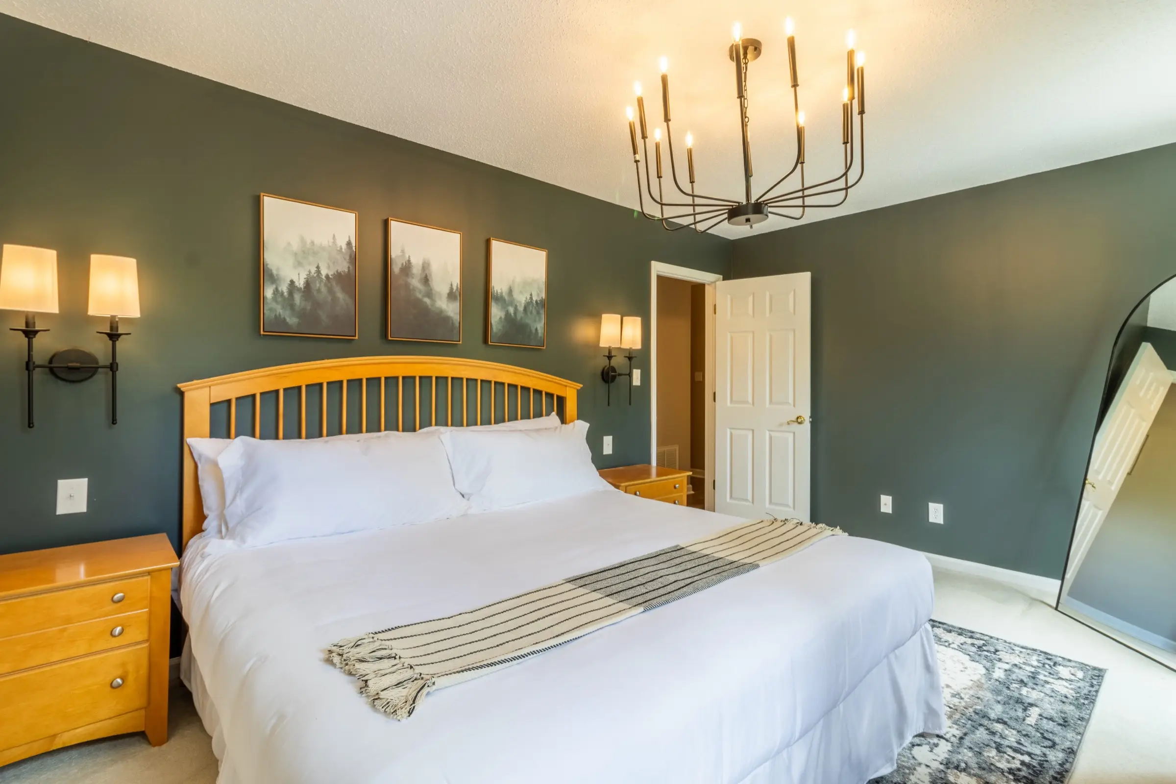 The Primary Bedroom from a second angle, showing the dresser and wall-mounted television.